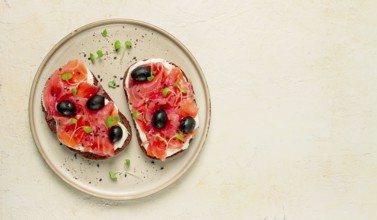 Sandwiches with red fish, cream cheese, olives and microgreens, breakfast