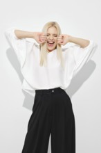 Woman screaming with joy or happiness on white background