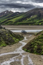 Off-road vehicle in volcanic landscape, Moss-covered mountains, Rhyolite mountains, Volcanic