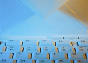 The keyboard of a computer and an envelope. Communication via e-mail, The keyboard of a computer