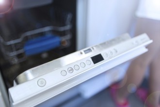 Dishwasher door partly open, showing control panel buttons