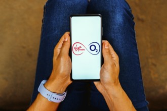 In this photo illustration, the Virgin Media O2 logo is displayed on a smartphone screen