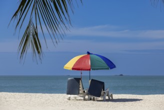 Parasol with sun loungers on a sandy beach, Chenang Beach, Langkawi, Kedah State, Malaysia, South