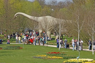 Visitors, dinosaur statue, Tulip Festival, garden show, Kaiserslautern, Rhineland-Palatinate,