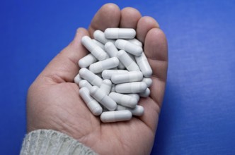 Large white pills fell from a large white bottle. Concept of drugs. Life without drugs and