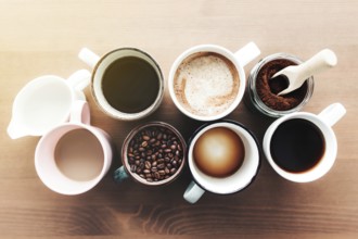 Multiple coffee cups and multicolored mugs with americano, espresso, latte and cappuccino, milk