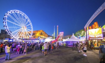 Calgary, Alberta, Canada. Jul 22, 2024. A vibrant evening at Stampede Park, featuring a brightly