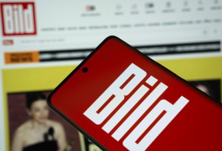 The logo of the German newspaper Bild is displayed on a smartphone screen, and the website bild.de