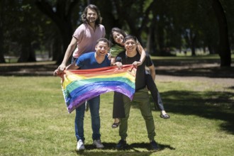 Group of latin friends holding the LGBT flag