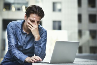 Stressed businessman after project failure. Confused young man frustrated by online problem