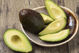 Avocado isolated on a wooden table