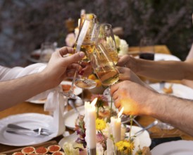 HAppy friends saying cheers and showing their champagne glasses full of sparkling wine to each