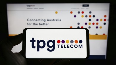 Stuttgart, Germany, 12-30-2022: Person holding cellphone with logo of Australian company TPG
