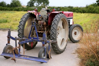 Agriculture aged red tractor retro vintage machine