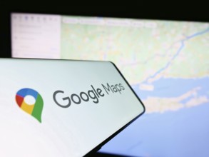 Stuttgart, Germany, 03-10-2023: Smartphone with logo of web mapping platform Google Maps on screen