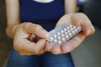March 16, 2024, Brazil. A woman holds her birth control pill. The medication is a pill that