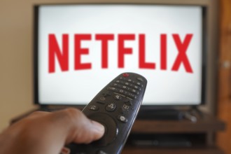 April 20, 2024, Brazil. In this photo illustration, a hand holding a TV remote control in front of