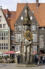 Stone statue with armour and coat of arms Bremen Roland on the market square in the old town of