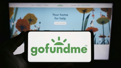 Stuttgart, Germany, 01-12-2023: Person holding smartphone with logo of crowdfunding platform