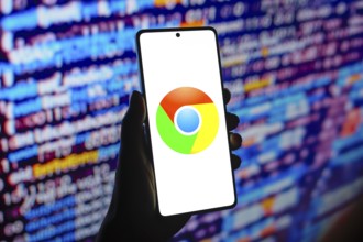 In this photo illustration, the web browser Google Chrome logo is displayed on a smartphone screen