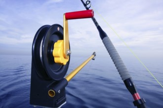 Downrigger angler fishing tackle with blue sea water background