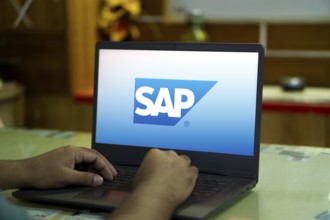 SAP SE logo is displayed on smartphone. SAP SE is a German multinational software company based in