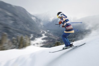 A female athlete skier rides a freeride in a winter forest in the mountains. Jump against the