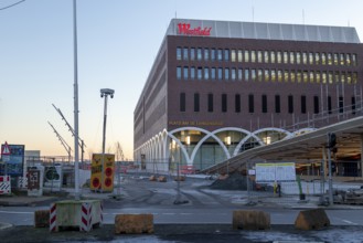 Construction site of the Westfield Hamburg-Überseequartier shopping centre in the evening light,