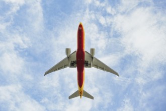 An airplane flying low on landing at Leipzig Airport