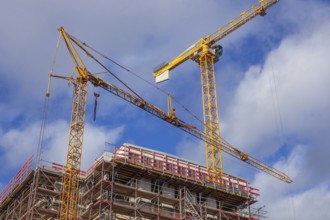 Construction site, shell of a residential building with construction cranes, Bremen, Germany,