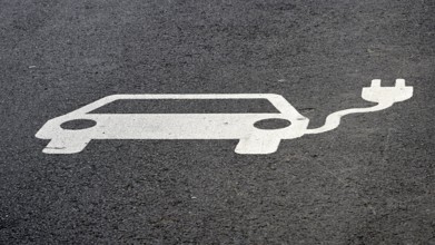 Indication of an electric charging station on the asphalt of a street in Leipzig