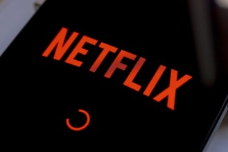 In this photo illustration, the Netflix streaming app logo is displayed on the smartphone screen