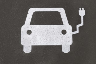 electric car charging station pictogram symbol painted on asphalt - e-mobility concept