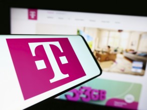 Stuttgart, Germany, 09-11-2023: Mobile phone with logo of telecommunications company Deutsche