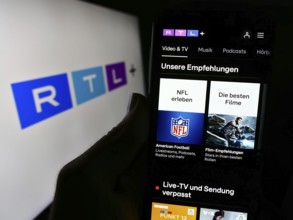 Stuttgart, Germany, 02-13-2024: Person holding cellphone with webpage of German entertainment