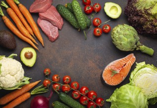 Assorted food raw products: vegetables, beef meat steak, fish salmon fillet on dark rustic brown
