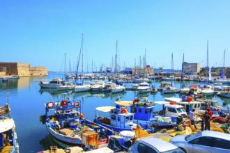 Heraklion, Greece, April 27, 2019: Crete island old harbor with fishing boats and Venetian fortress