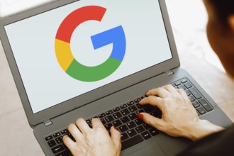 In this photo illustration, the Google logo is displayed on a notebook screen