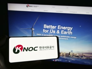 Stuttgart, Germany, 11-16-2023: Person holding smartphone with logo of petroleum company Korea