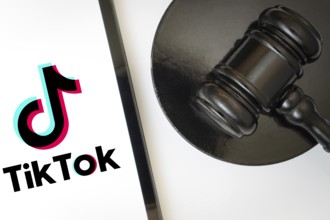An iPad displays the tiktok logo alongside a judge's gavel