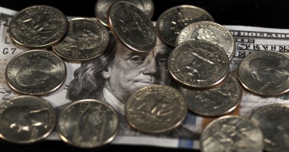 Quarter Dollar Coins Falling, Rolling and Sliding on Black Background