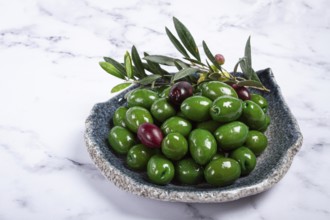Chalkidiki olives, classic Greek green olives, in a plate, top view, no people