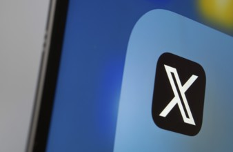 A close up of an iPad screen displaying the X (twitter) app
