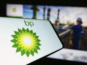 Stuttgart, Germany, 11-16-2023: Cellphone with logo of British oil and gas company BP plc in front