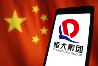 In this photo illustration, the Evergrande Real Estate Group logo is displayed on a smartphone