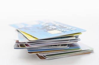 A pile of several colored credit cards