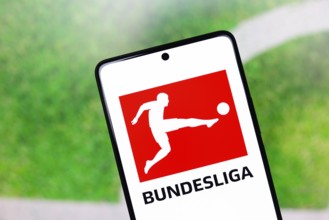In this photo illustration, the Bundesliga logo is displayed on a smartphone screen