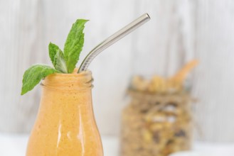 Seasonal pumpkin carrot smoothie drink detox with eco metal drinking straw Glass jar granola muesli