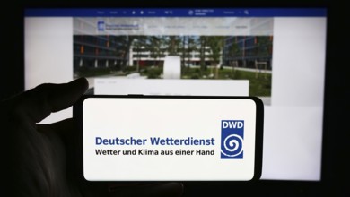 Stuttgart, Germany, 06-06-2024: Person holding cellphone with logo of German meteorological service