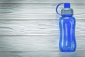Plastic shaker for athletics on wooden board fitness concept